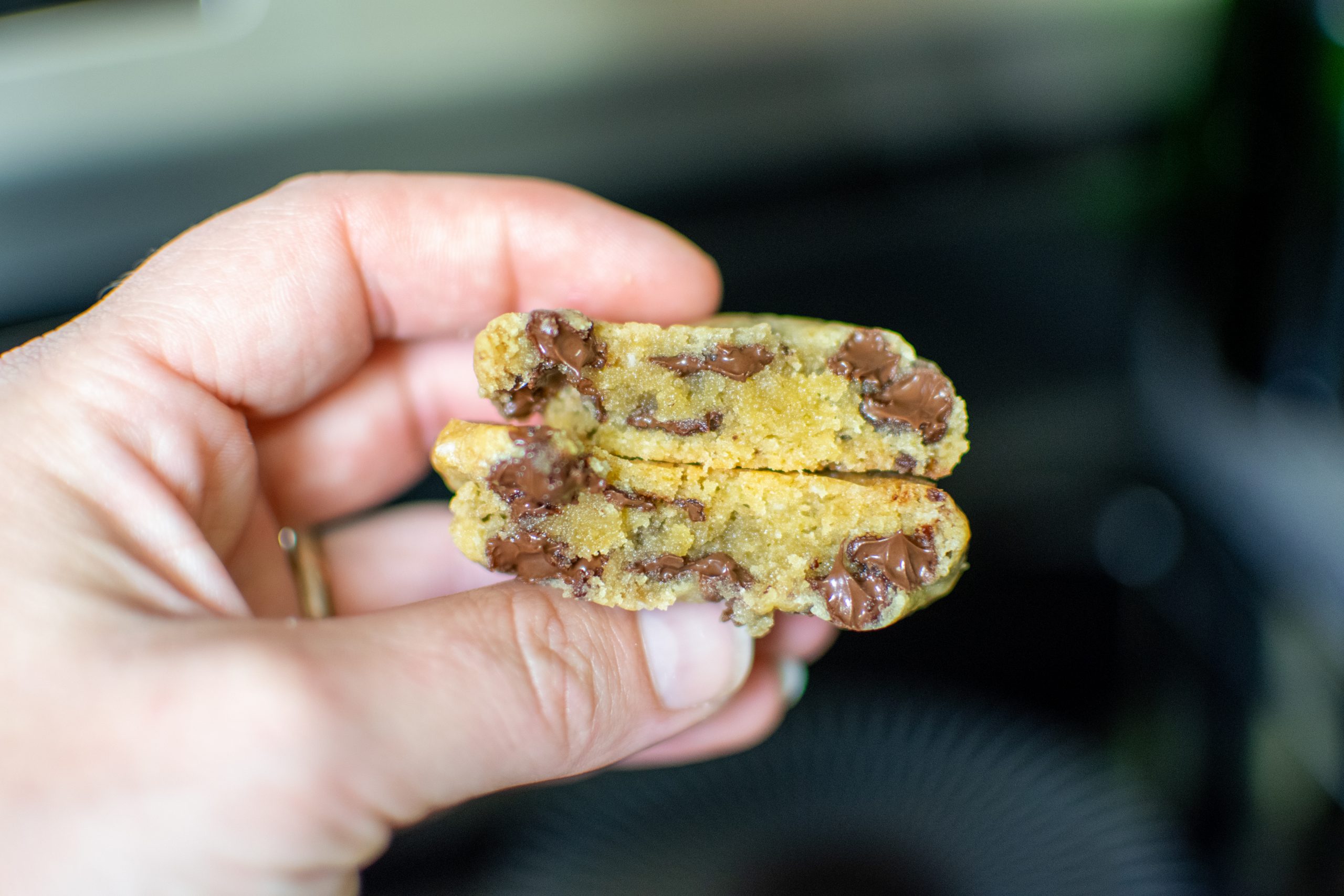 broken chocolate chip cookie showing the soft interior