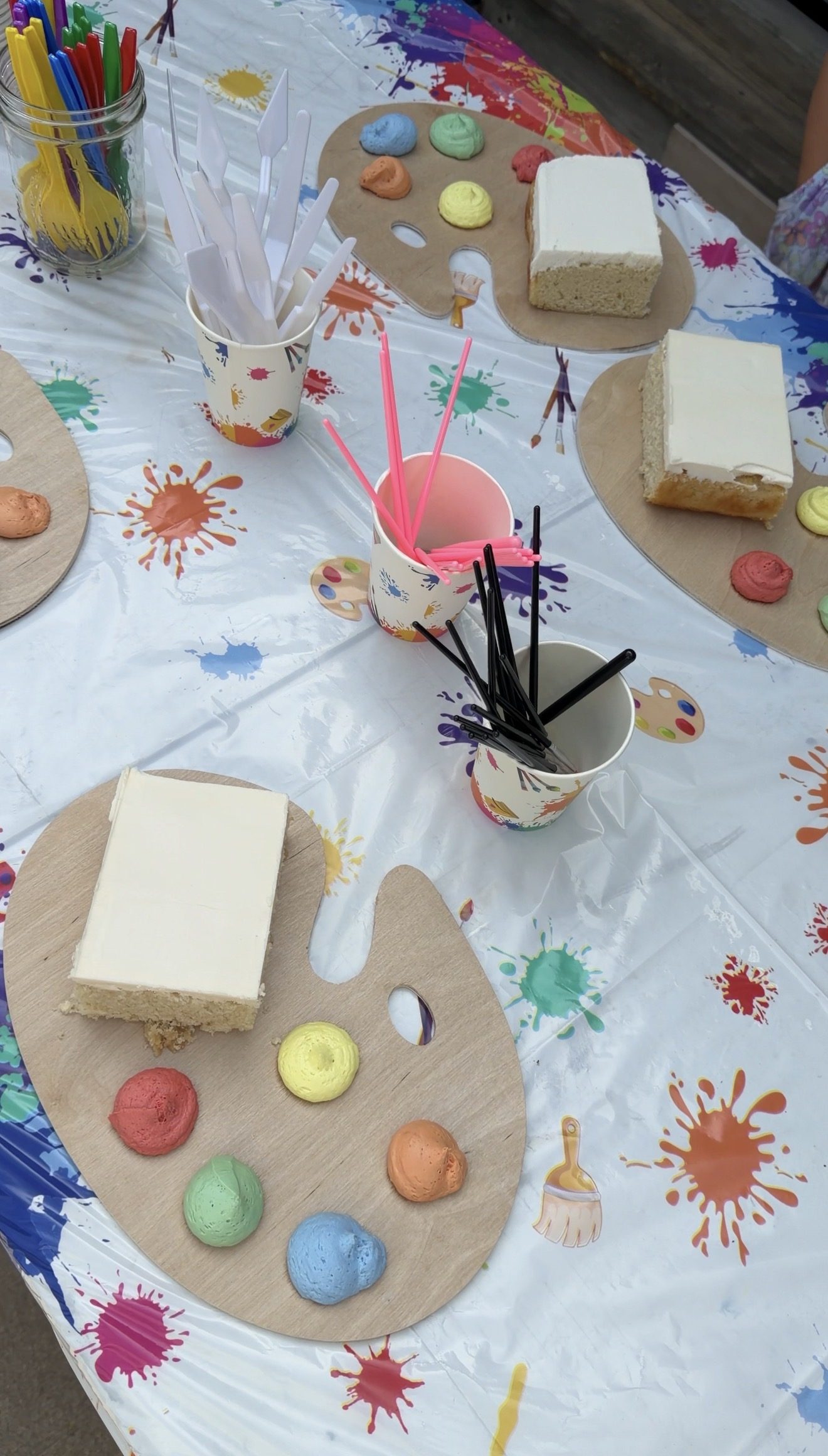 Paint-your-own cake palettes set out with brushes and palette knives