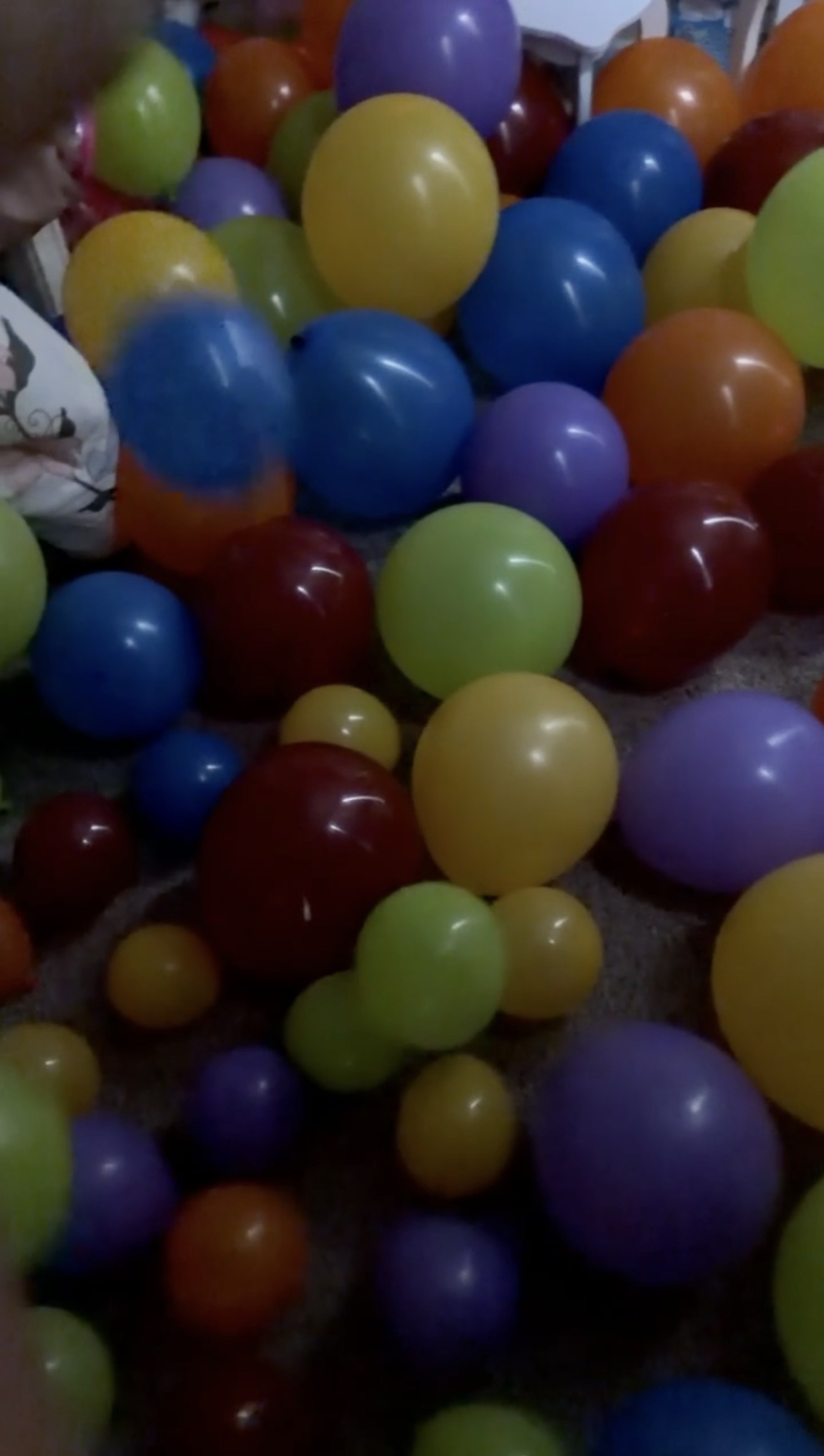 Colorful balloons covering the floor for Finley’s birthday-morning tradition