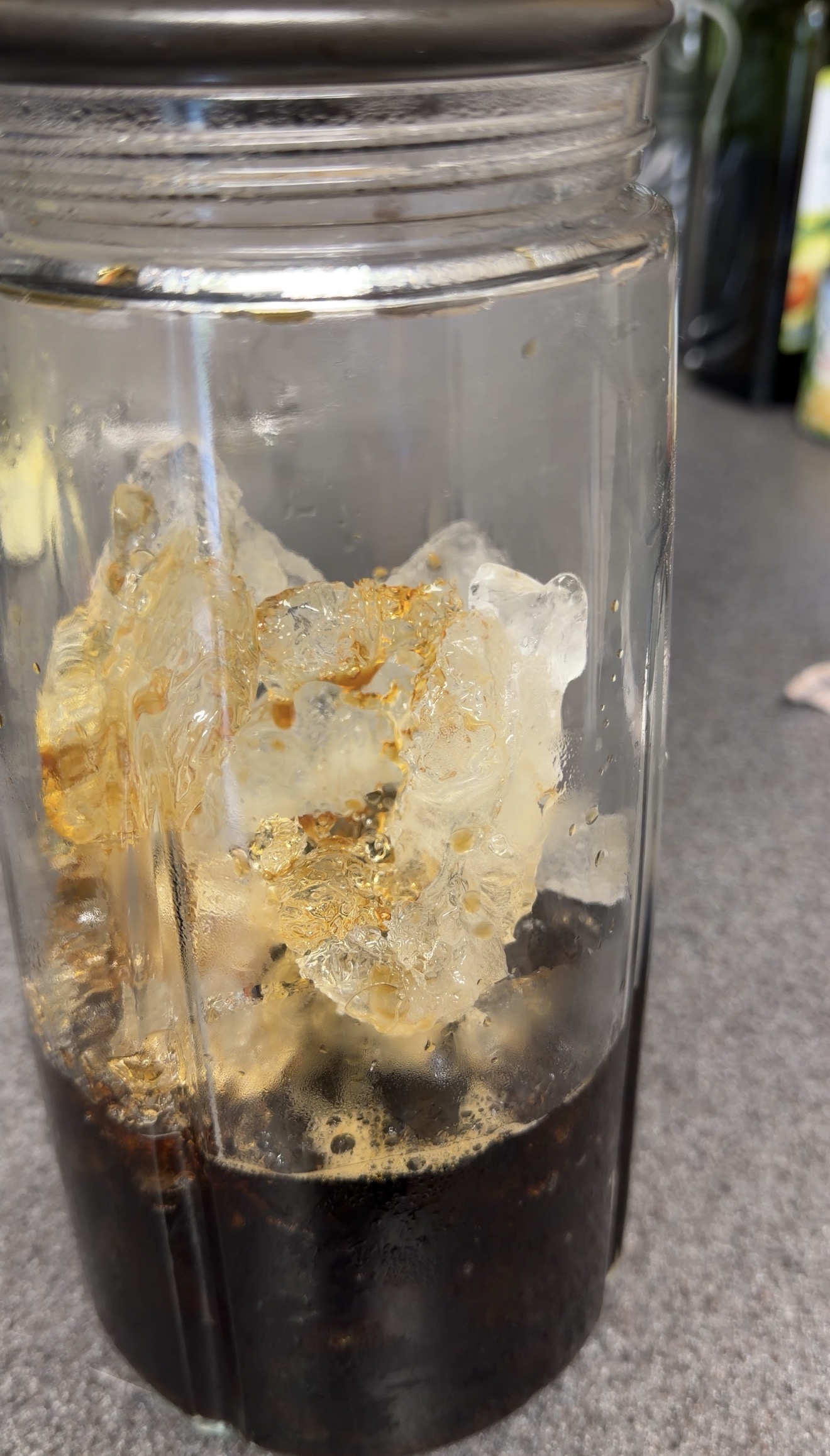 Fresh hot coffee melting and chilling against the ice inside the pitcher.